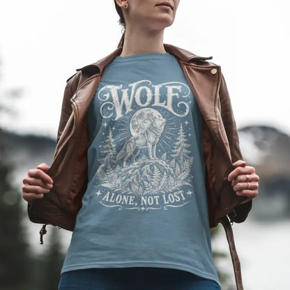 Person wearing Wolf tee in Indigo Blue, a mystical animal yoga shirt outdoors by a mountain lake — Wild Animals collection by Ramro Yoga Wear