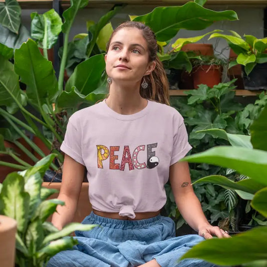 Light Pink Yin Yang Peace T-Shirt lifestyle image featuring peaceful retro typography in a calming natural setting.