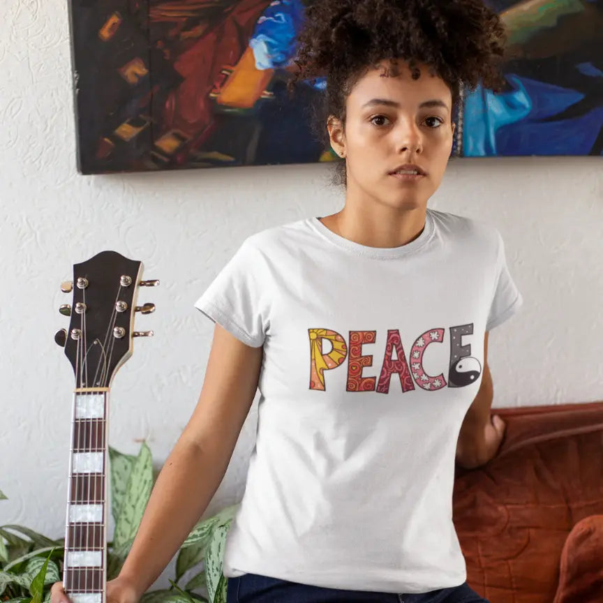 Person wearing Yin Yang Peace T-Shirt White sacred yoga shirt outdoors playing guitar — The Vault collection by Ramro Yoga Wear